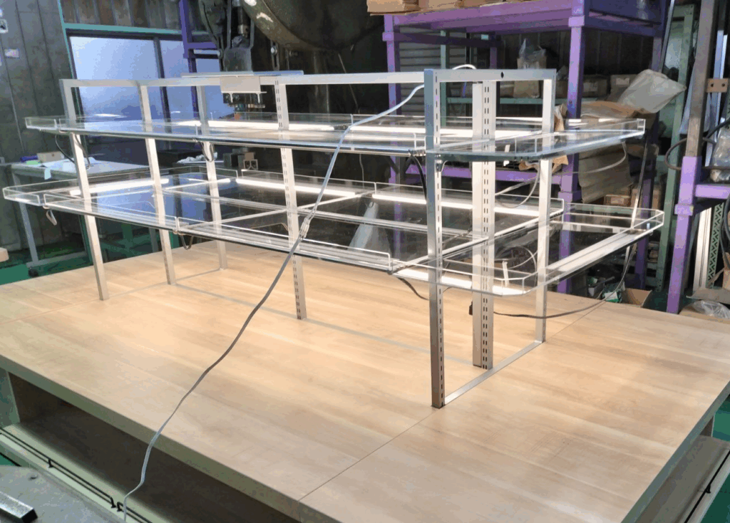 デリカ什器のアッセンブル工程｜スチール・アクリル・LEDを組み合わせて最終工程へ